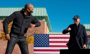 Obama and Biden together in Flint. Obama said: ‘Joe Biden tries to live the values we cherish: honesty, hard work, kindness, humility, responsibility, helping someone out.’