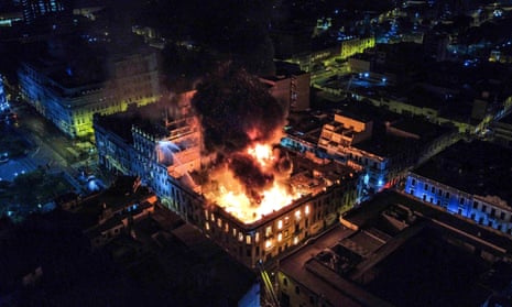 A fire burns in a mansion near the historic Plaza San Martin in Lima, Peru, where anti-government protestors clashed with police.