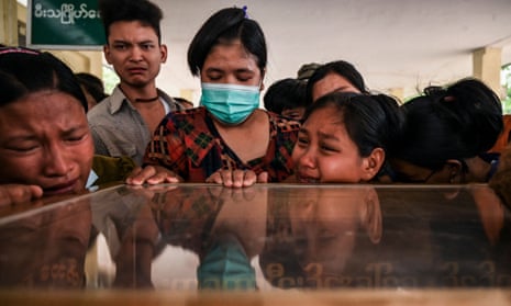 Relatives mourn over the dead body of Aung Ko Oo, who died on 29 March during a protest in Yangon, Myanmar amid a crackdown by security forces on demonstrations against the military coup.