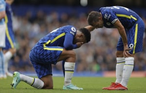 Cesar Azpilicueta of Chelsea checks on Reece James who is down injured.