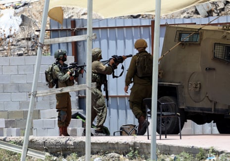 Israeli soldiers take position during an army operation in the West Bank city of Nablus, 23 July 2025.