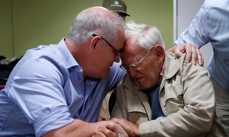 Scott Morrison comforts 85-year-old Owen Whalan, who was evacuated from his home to the Taree evacuation centre