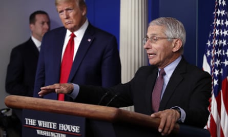 Donald Trump listens as Anthony Fauci speaks at the White House, in April.