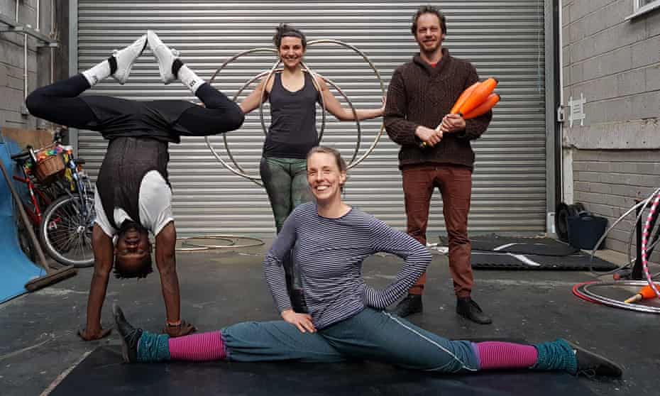 Sexual Health Circus members with hoops,juggling equipment and one doing the splits