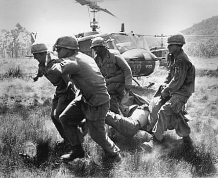 The body of a soldier is carried to an evacuation helicopter by troops from US 1st Cavalry Division in the Ia Drang Valley in November 1965.
