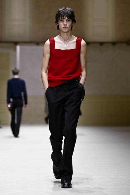 Young male model in a red camisole and black baggy trousers