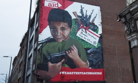 Artwork is seen on a London street depicting a young Yemeni boy holding a gun