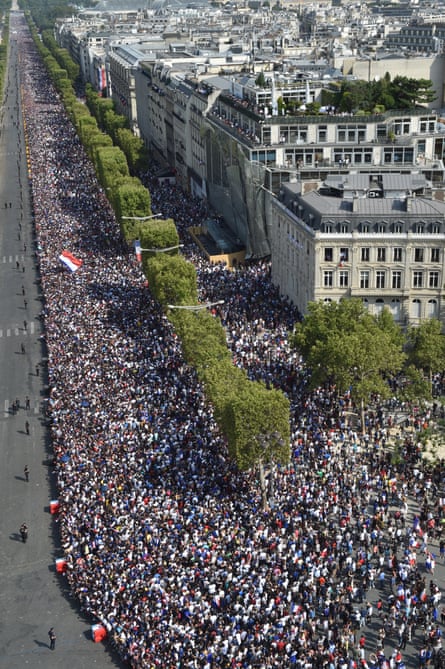 A huge crowd lines the Champs Élysées to welcome home the France team