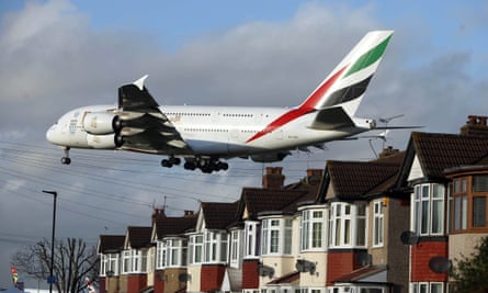 A plane comes in to land over houses