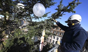 A worker installs lights on a huge Christmas tree in Strasbourg, France.