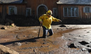 Firefighter Alex Jimenez wades through the mud in Montecito after finding remains of a victim of the flash flood.