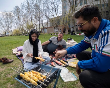 An Iranian family prepares kebabs at a park in central Tehran.