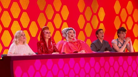 Drag Race España judges react with shocked expressions behind a desk on set