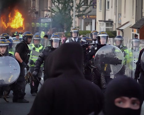 Riot police on the streets of Southport and rioters in balaclavas