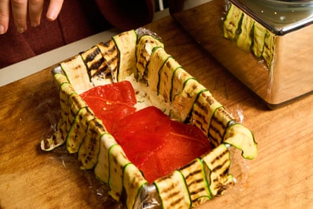 Zucchini and capsicum layered in a rectangular baking tin.