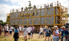 A Terminal 1 sign with people standing in front.