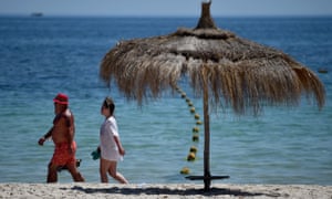 Tourists continue with their holidays at Marhaba beach near where 38 people were killed in Sousse, Tunisia.