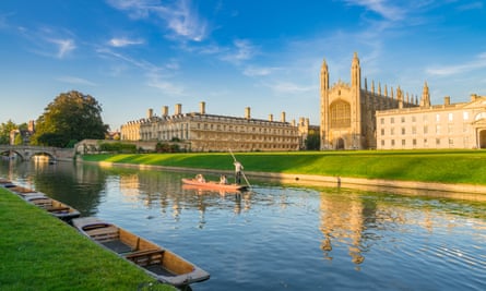 A scene of a boat being punted down a river next to a university building 