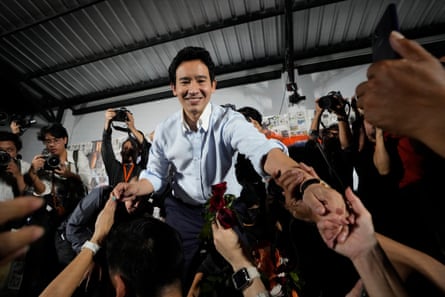 Former leader of Move Forward Party, Pita Limjaroenrat, shakes hands with his supporters.