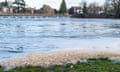 Sewage foam on the River Thames by Marlow Weir in Buckinghamshire.
