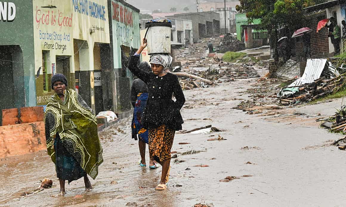 People walk in streets left devastated by a cyclone