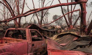 A red fire retardant suffocates homes destroyed by the Almeda fire in Talent, Oregon.