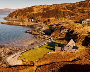 A scattering of stone and timber buildings on the edge of a rocky bay