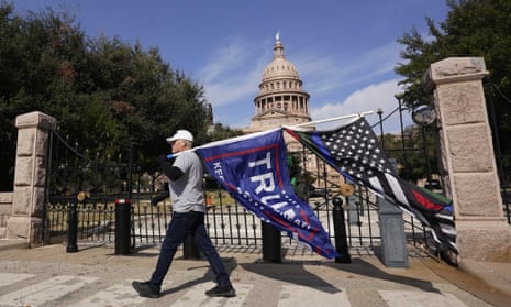 A supporter of Donald Trump walks past Austin’s Texas state capitol on Saturday