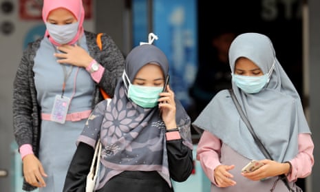 Indonesian women wear masks in a public area in Depok, West Java, Indonesia