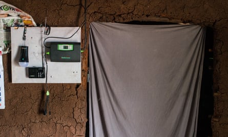 Control unit fixed to a mud wall in a home powered by M-Kopa solar technology in a village in Kenya