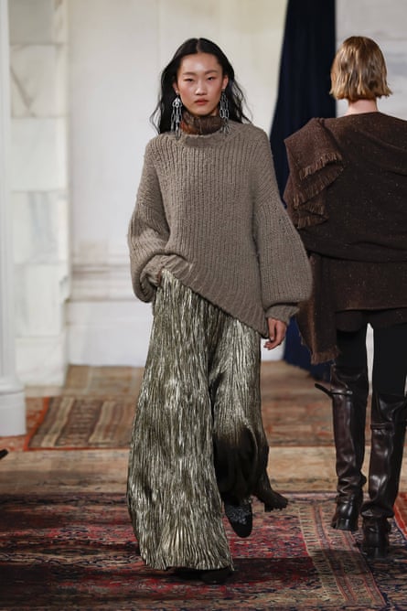 Model walks in runway show.