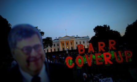 A cardboard cutout of William Barr is seen as protesters hold signs which read “Barr Coverup,” following the release of the Mueller report on 18 April 2019.