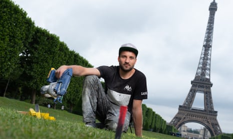 Saype at the Champs de Mars, Paris, working on his Beyond Walls land art project.