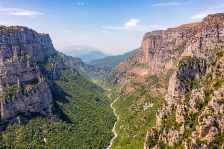 Steep sided gorge with rocky cliffs and trees on the base of the valley