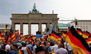 People wave German flags during an AfD rally at the Brandenburg Gate in Berlin. 6492.jpg?width=300&quality=85&auto=forma