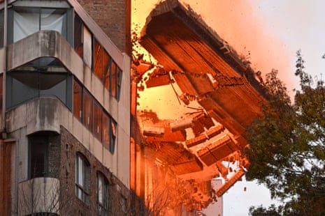 A wall collapses during the fire in Sydney.