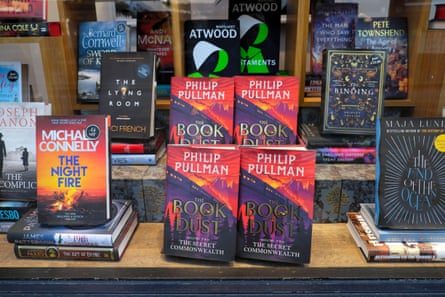 four copies of The Book of Dust on a display shelf