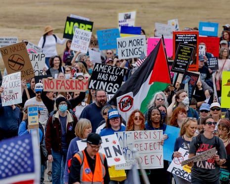 Demonstrators with the 50501 democracy movement march through Piedmont Park during an anti-Trump rally in Atlanta, Georgia.