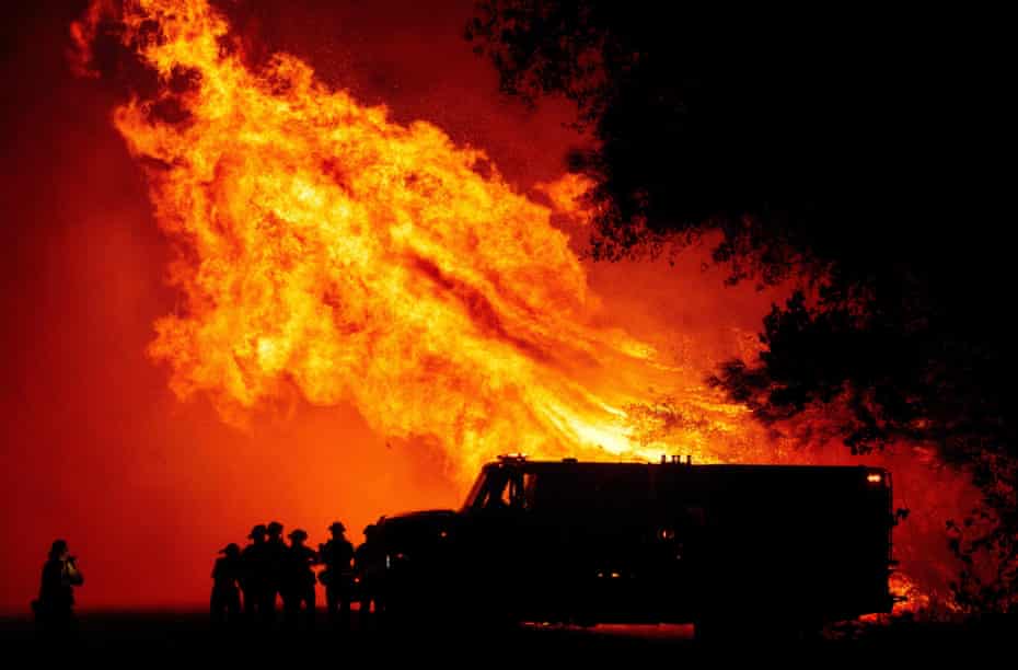 Flames tower over a fire engine in Oroville, California in 2020. Firefighters should be the last line of defence, say experts who want more funding for fire prevention.