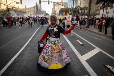 a woman holding a flyer with a photo of a man