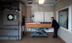 A crematory operator pushes the body of an unnamed veteran who died of Covid-19 to an incinerator in Frederick, Maryland.