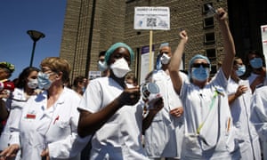 Medical staff demonstrate at a Paris hospital on Wednesday. French nurses and doctors demand better pay and a rethink of the health system.