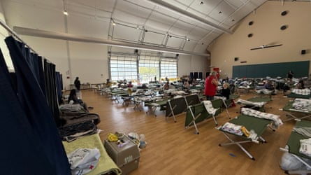 Hanger-type building with cots set up.