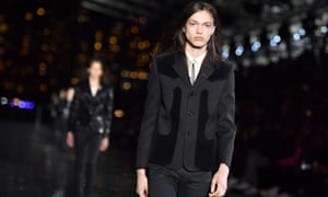 A model in a black jacket at the Saint Laurent show