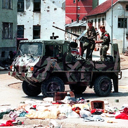 A Bosnian Serb armed vehicle crew drives through the deserted streets of Srebrenica.