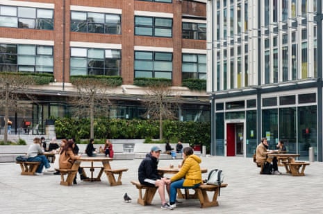 Students of The London School of Economics work on the campus benches in London, Britain, 24 March 2021.