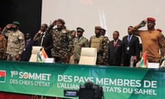 Col Assimi Goïita, Gen Abdourahamane Tiani, and Capt Ibrahim Traoré (R) salute as they stand to attention at the summit. All are wearing military uniform