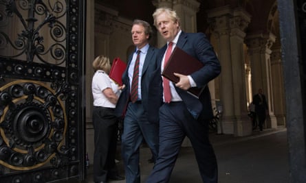 Boris Johnson (right) leaves the Foreign Office in London