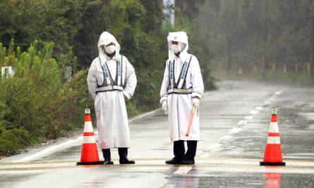 Security staff block a road leading to the crippled Fukushima nuclear plant in Japan. Despite being a nuclear level 7 accident, no one has died as a result of radioactive discharge.
