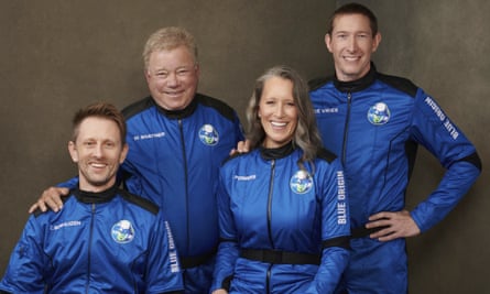 four people in blue jumpsuits